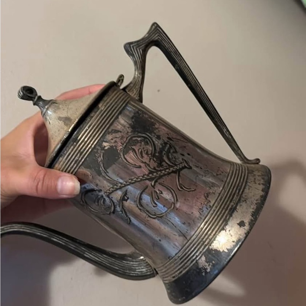 Ornate Silver Teapot with Floral Design